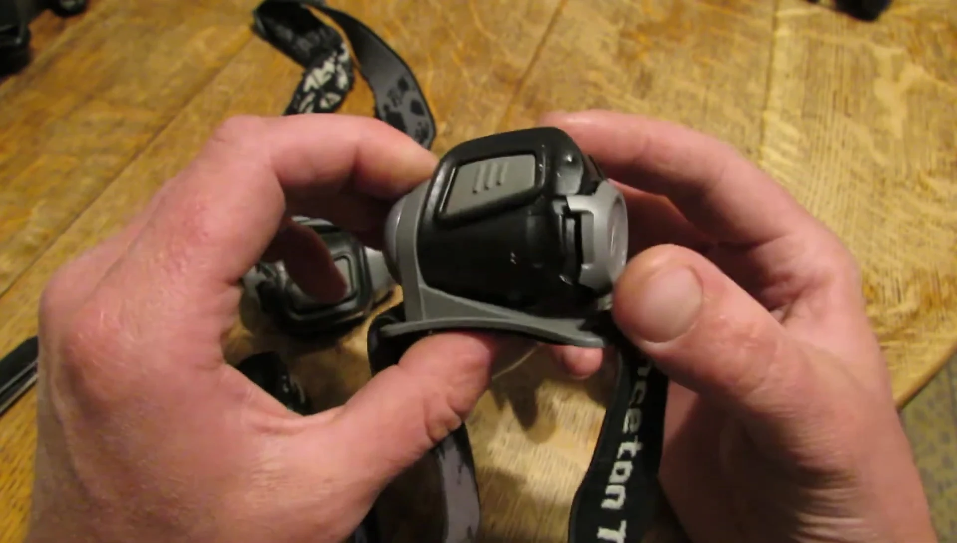 View of the Princeton Tec Remix headlamp showing the battery door and clip mechanism.