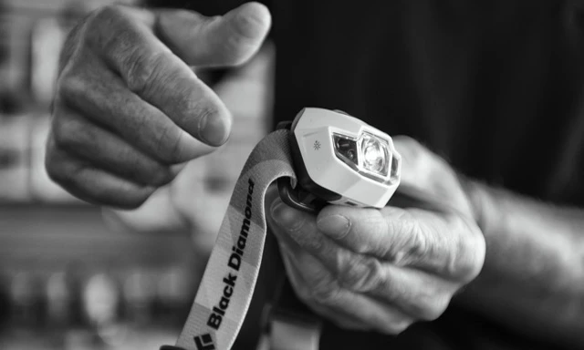 Hand demonstrating the Power Tap technology on the headlamp.