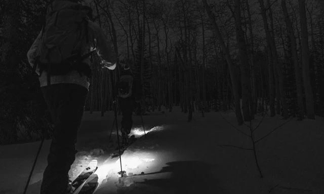 Image showing a person searching their backpack for the headlamp.