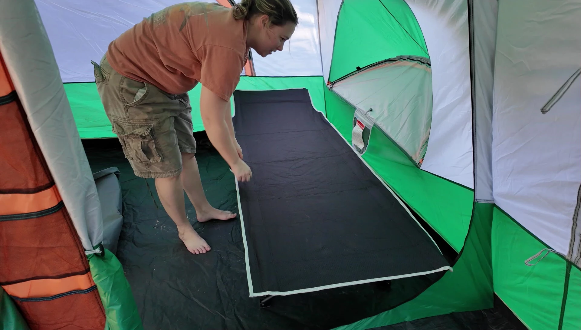 Placing the inflatable foam mattress on the cot