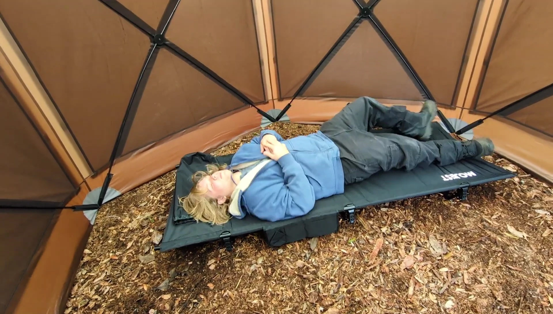 The user relaxing on the assembled cot