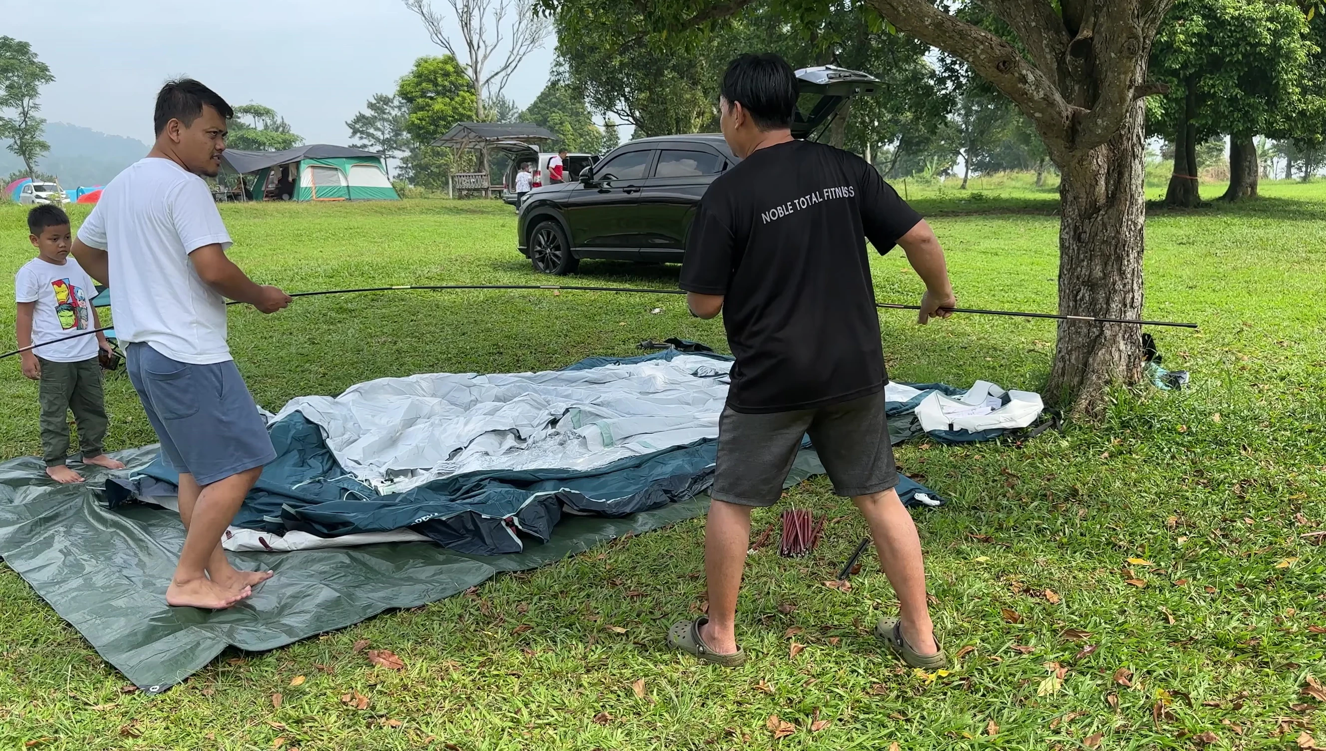 Shot of the initial steps in setting up the tent.