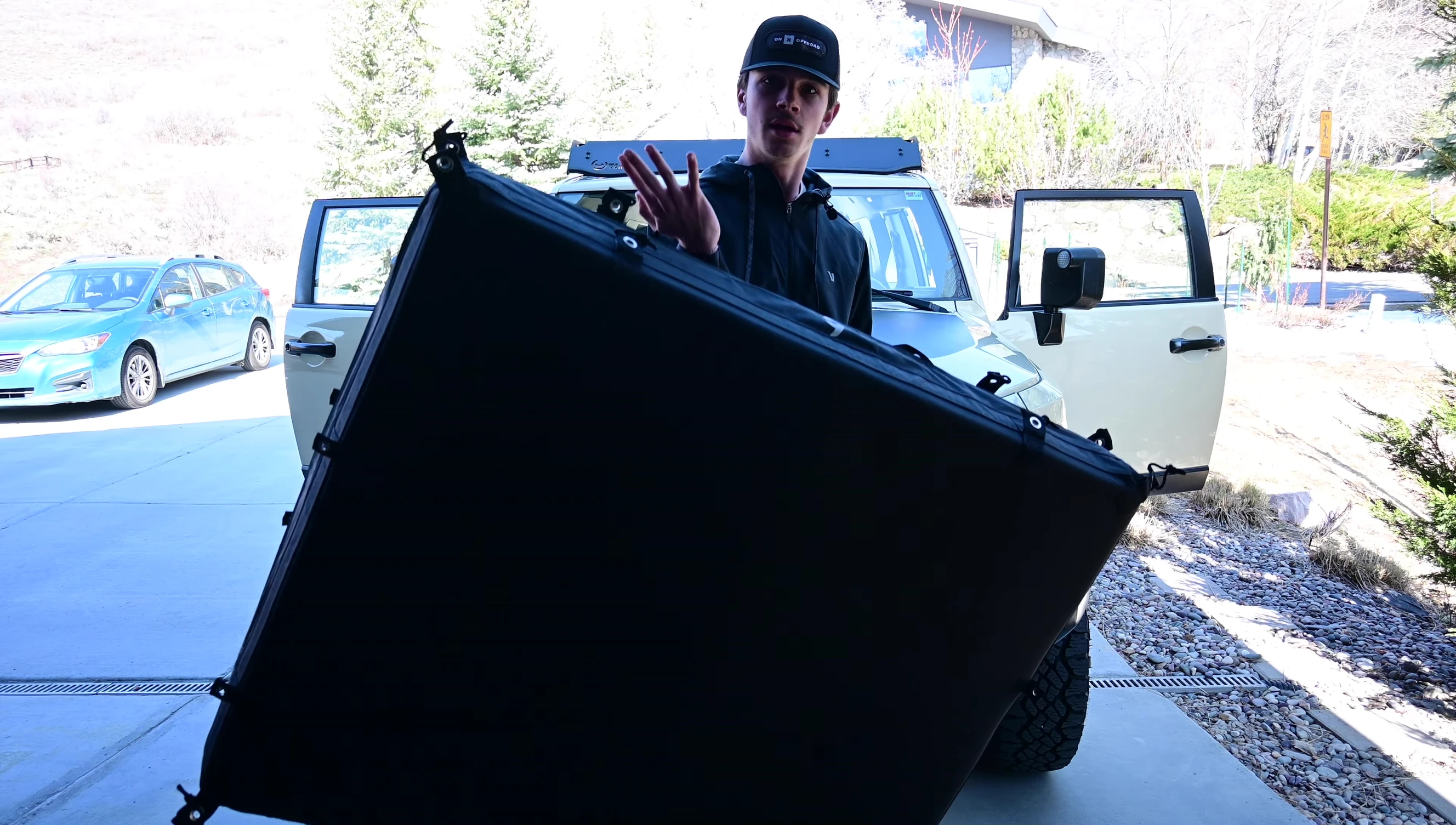 The speaker demonstrating how easily the tent is to curl.