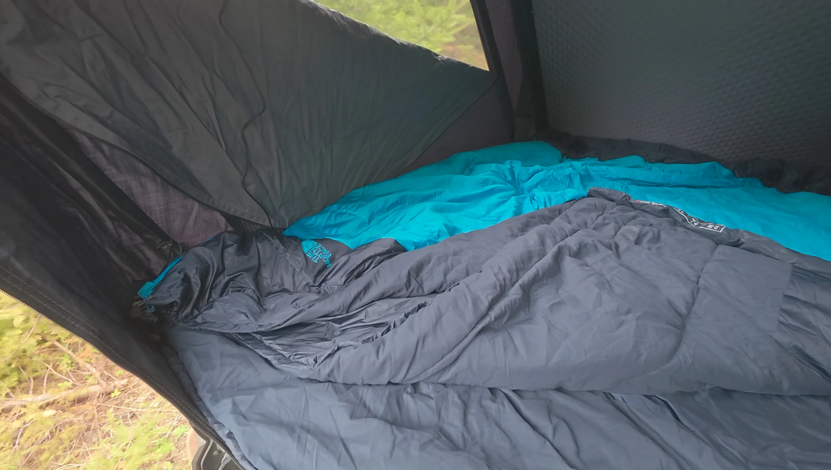 Both sleeping bags laid out in the tent to compare sizes.