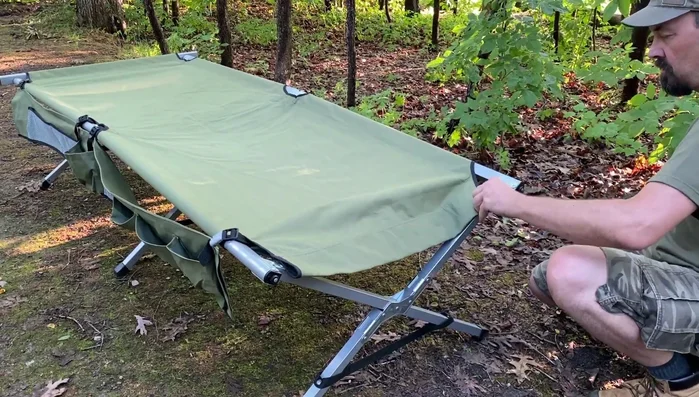 For the head-end bar, place it *underneath* the two long bars instead of forcing it into the bolts. This prevents frustration and makes the cot more comfortable.
