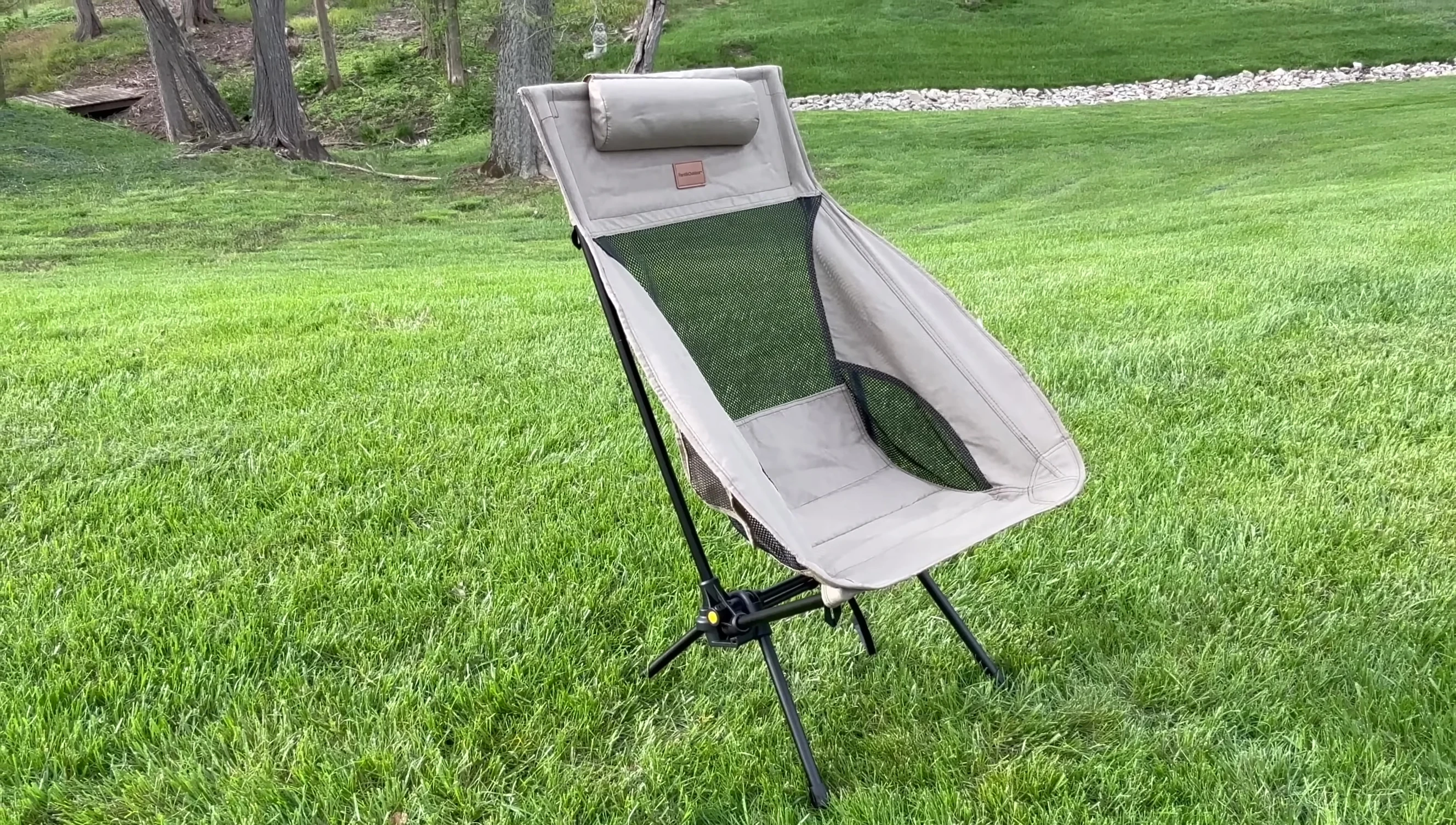 The reviewer sitting in the chair, highlighting comfort and rocking function