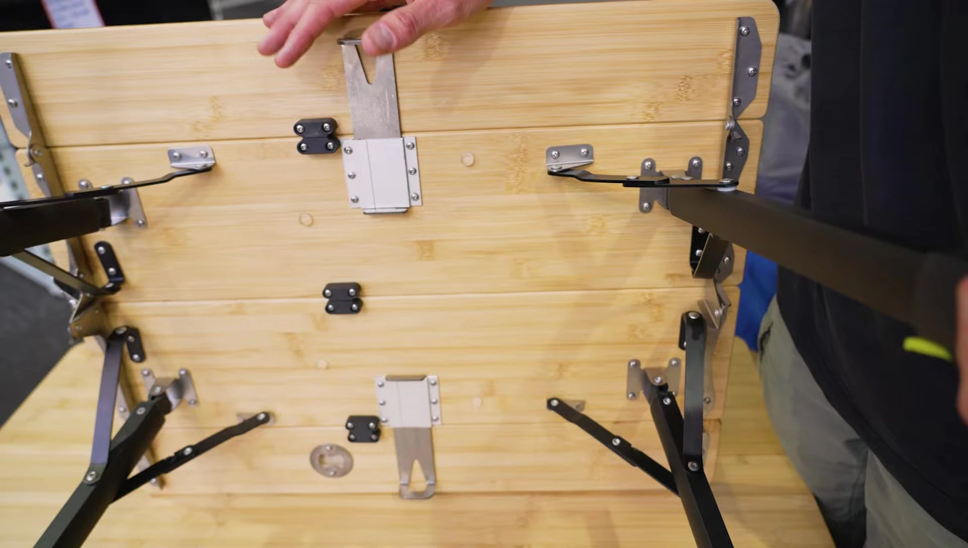 The built-in bottle opener on the table's underside.