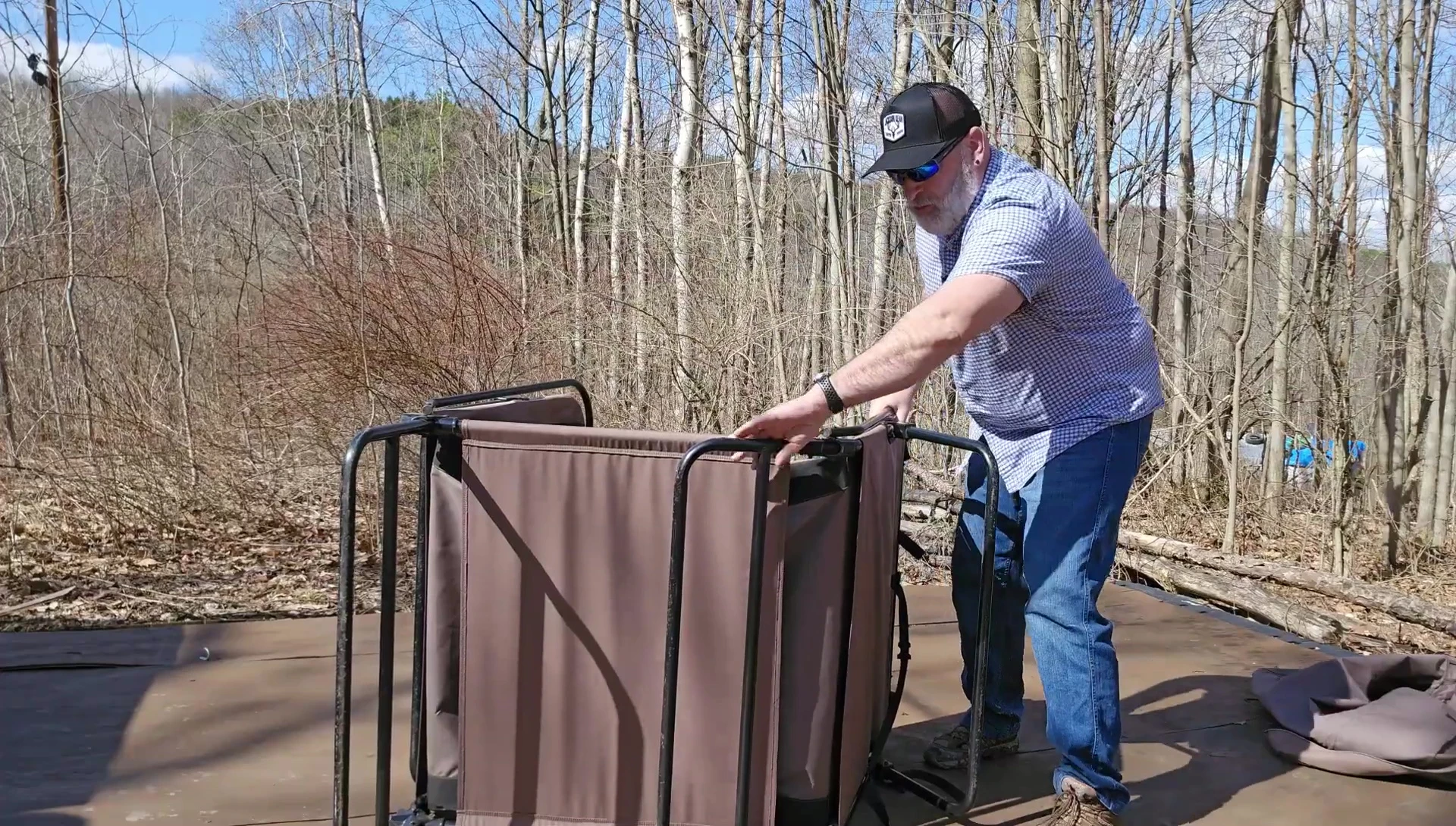 Securing the straps underneath the cot tent.