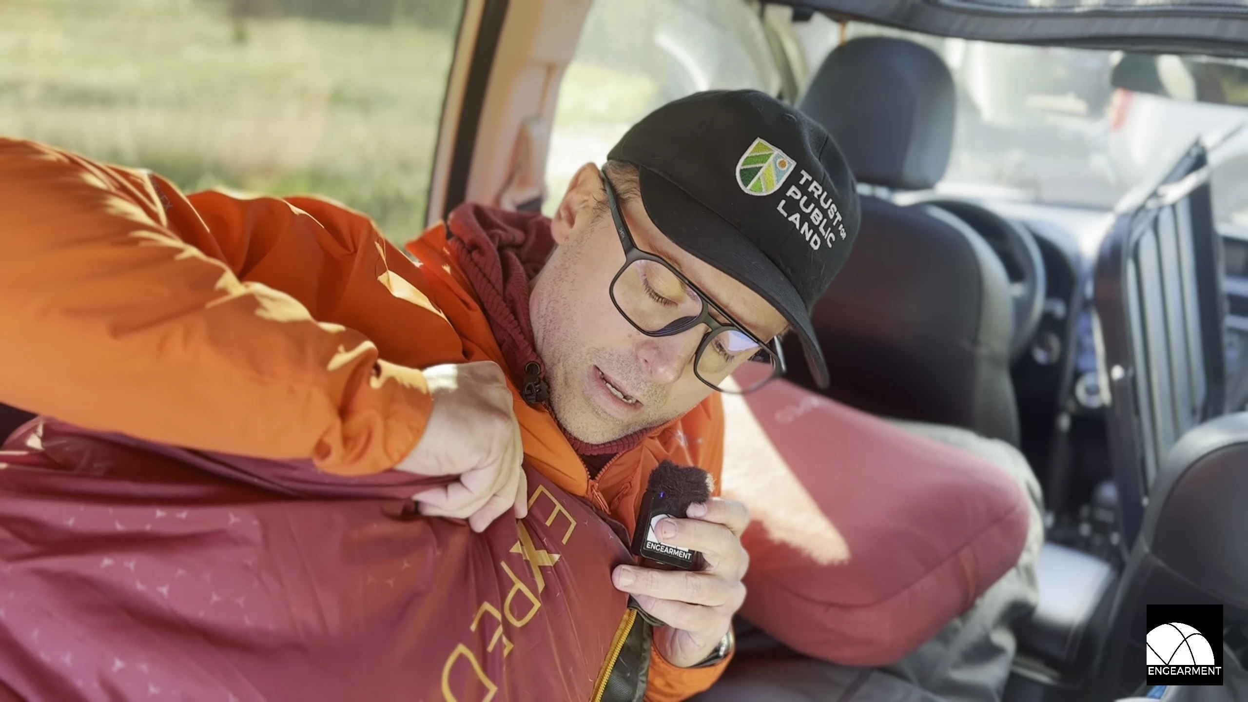 The reviewer showcasing the sleeping bag in a car camping setting.