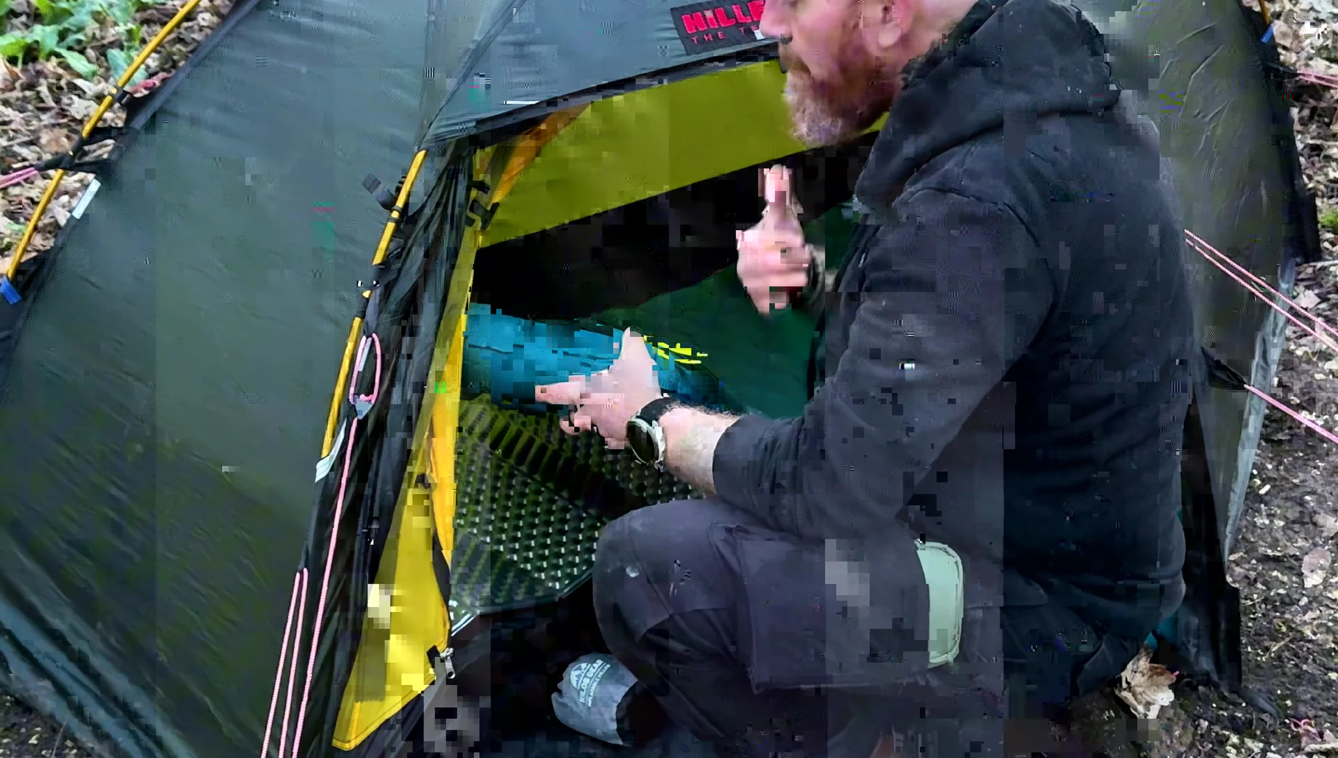 The reviewer inflating the sleeping pad with a pump