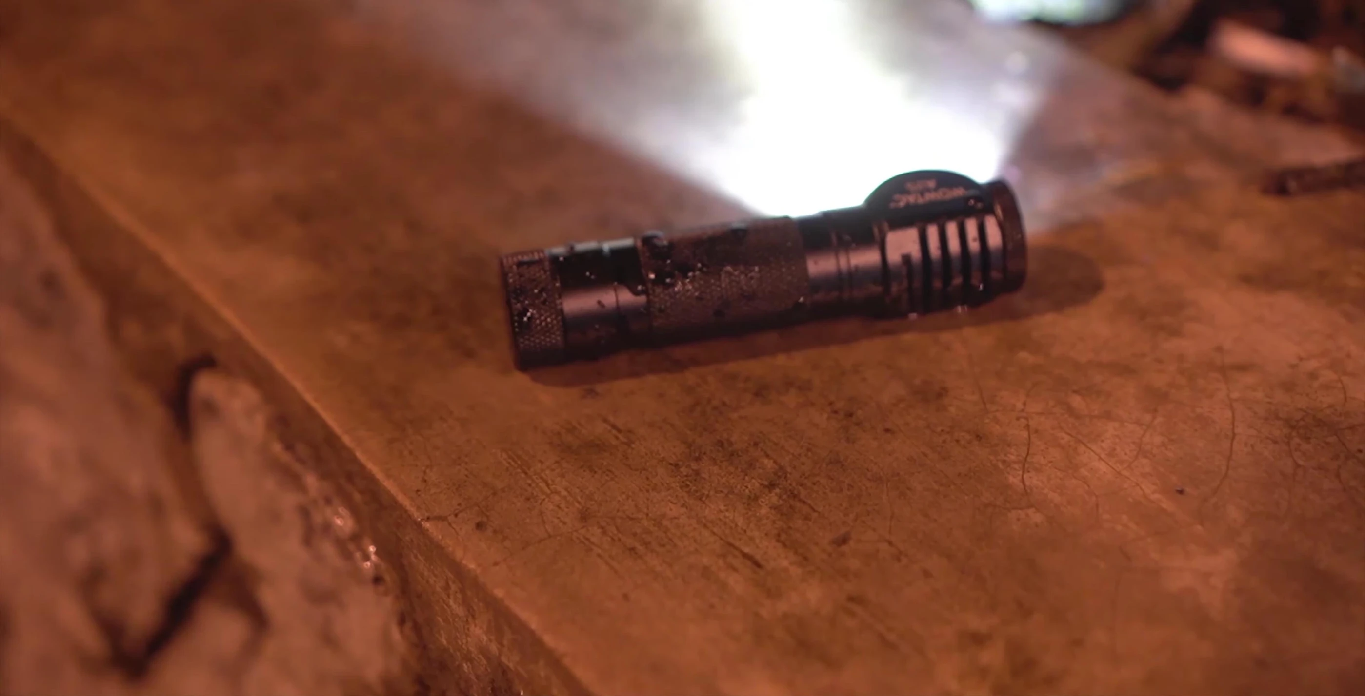 Hand demonstrating the one-handed operation of the Anker headlamp.