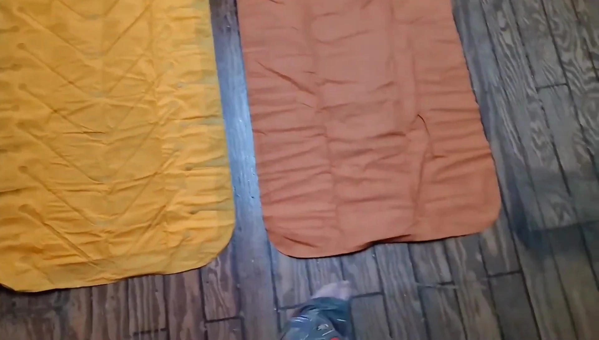Close-up shot highlighting the length difference between the two deflated sleeping pads.