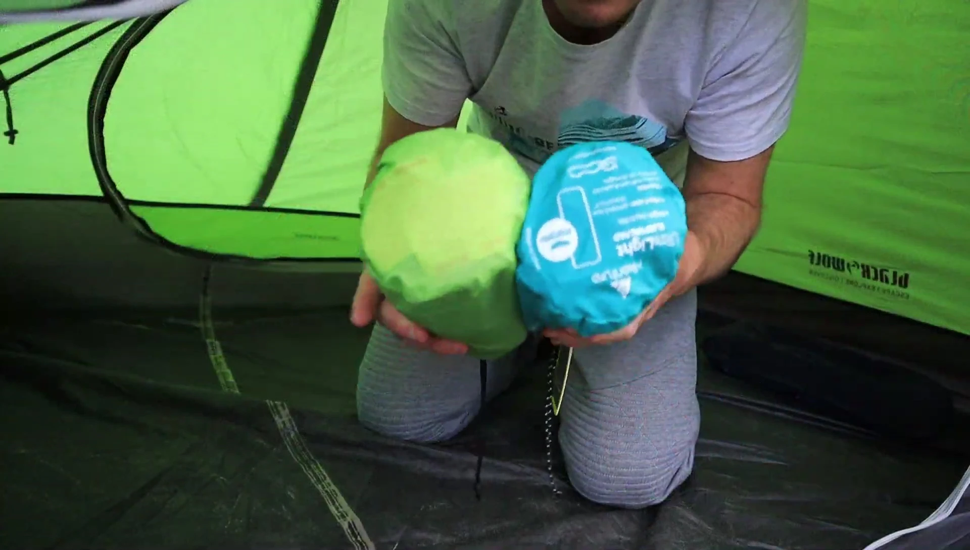 Close-up of both sleeping pads rolled up and packed, showcasing similar sizes.