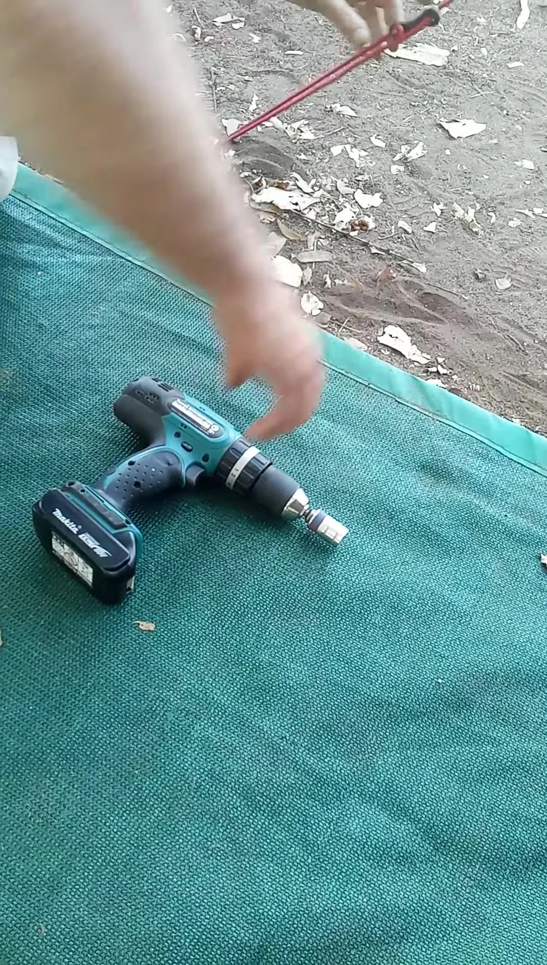 The cordless drill being used to insert the modified coach screw peg.