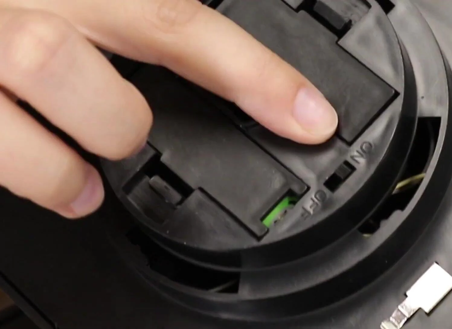 Person opening the top of the lantern to show the on/off switch.