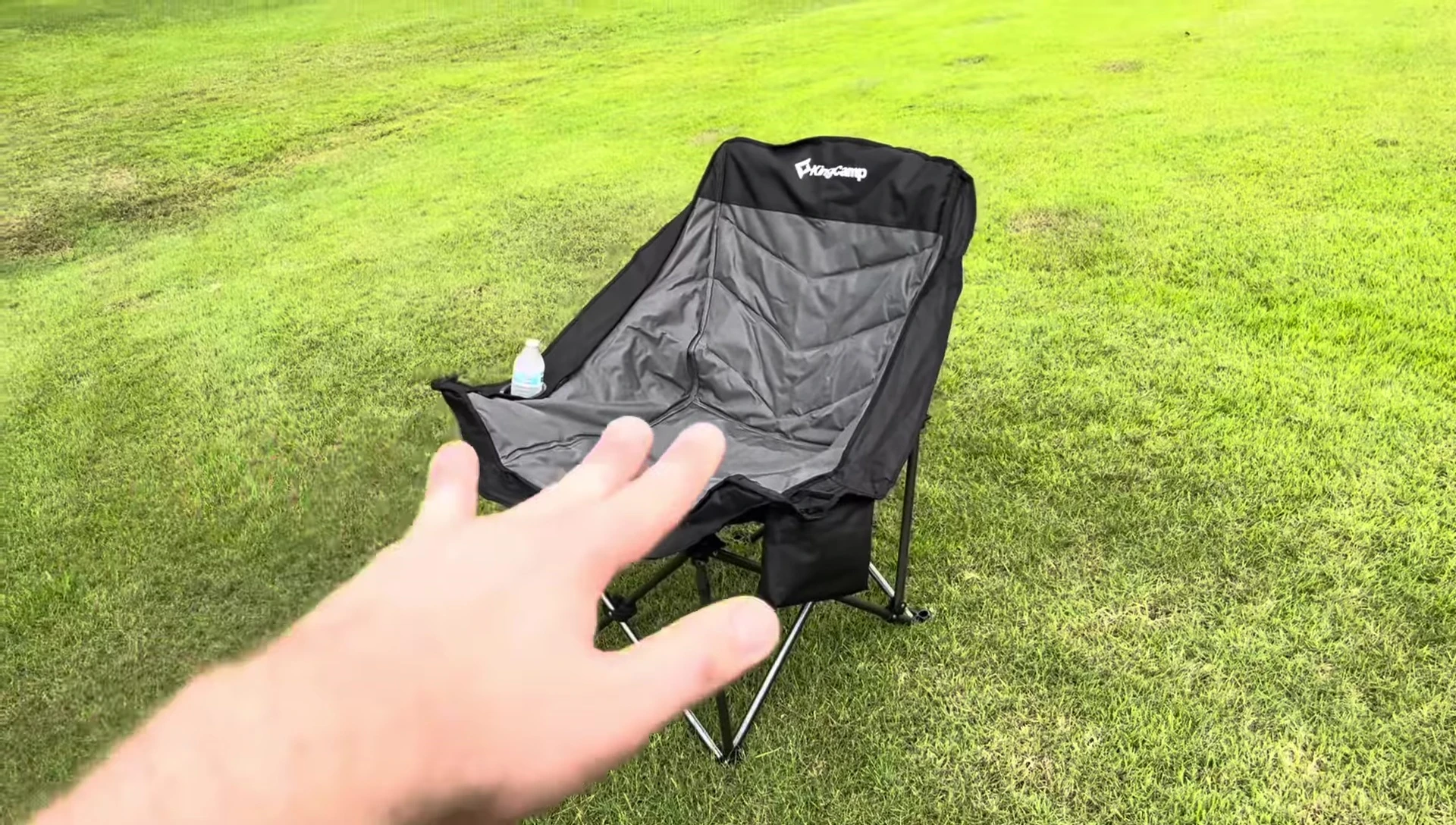 The reviewer demonstrating the ample space in the chair.