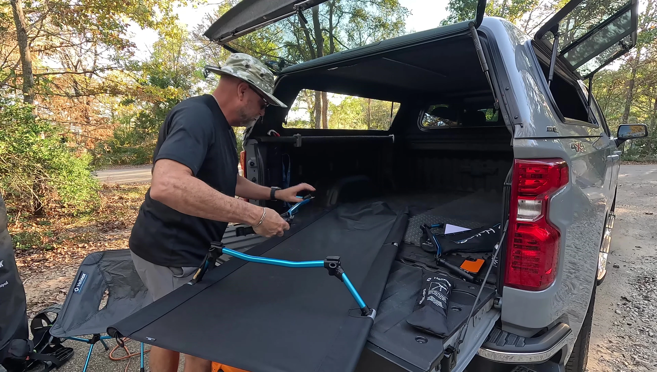 The reviewer securing the final components of the cot, showing the overall stability.