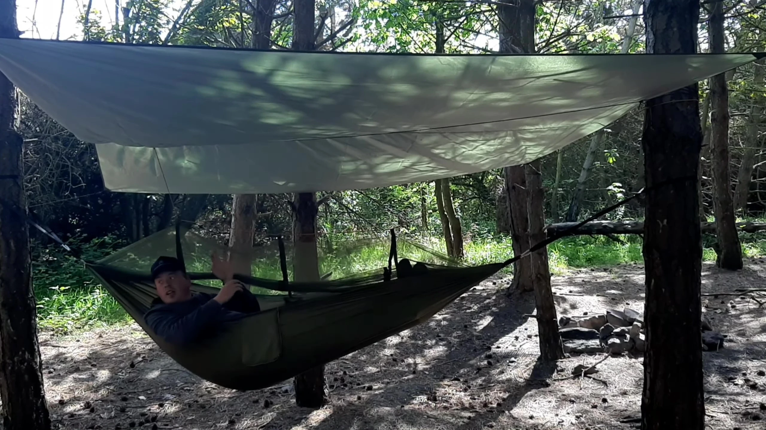 The reviewer sitting comfortably in the hammock