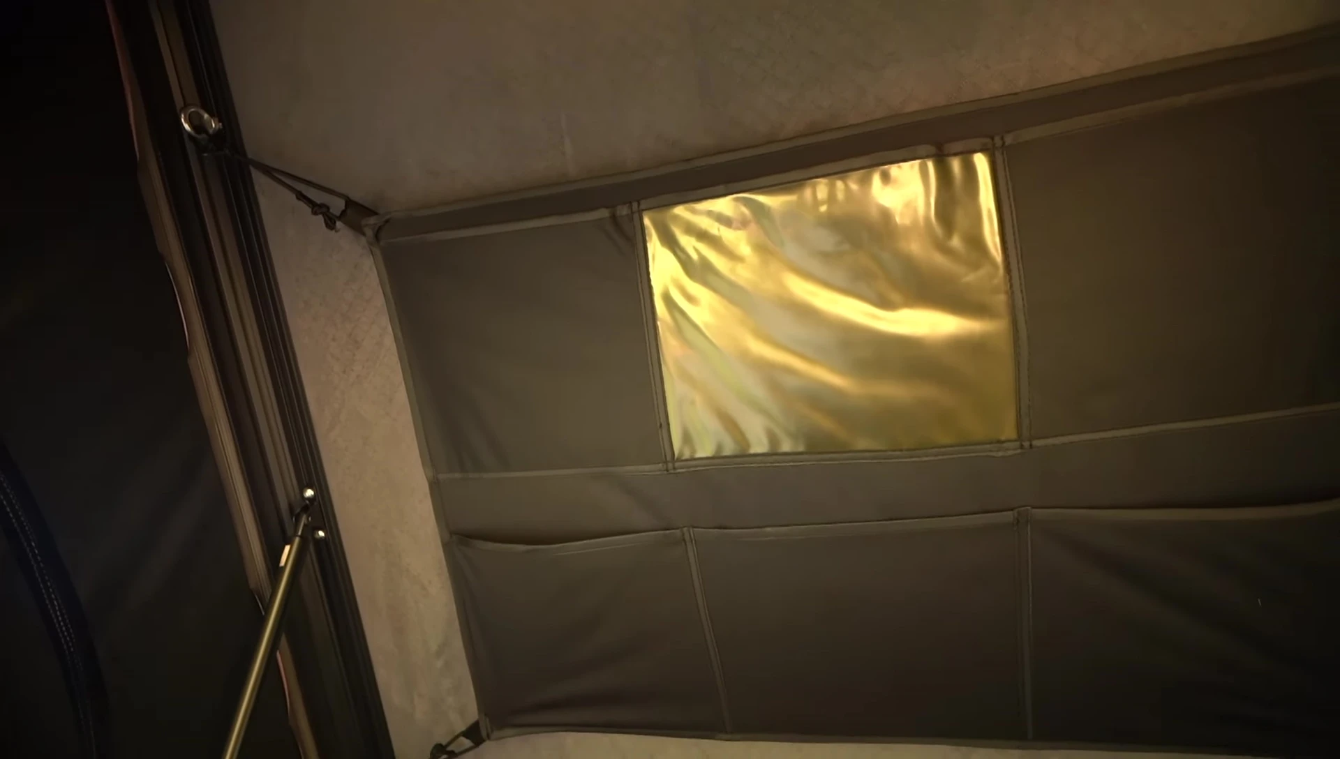 Interior view of the tent showing the storage compartment and mattress