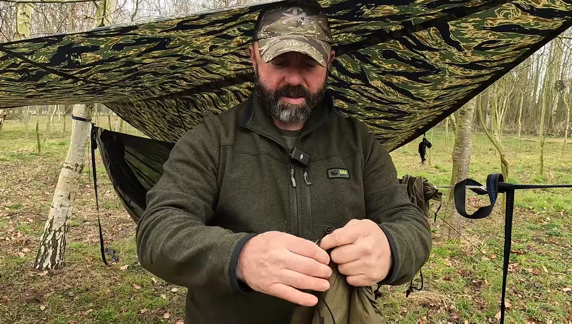 The reviewer showcasing the central attachment point and carabiner