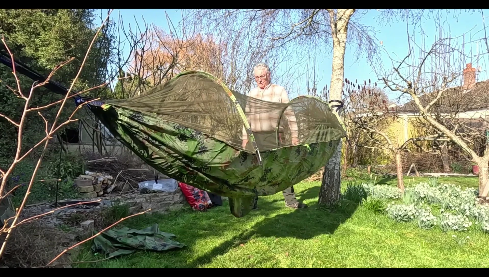 Hammock fully assembled and hung between trees.