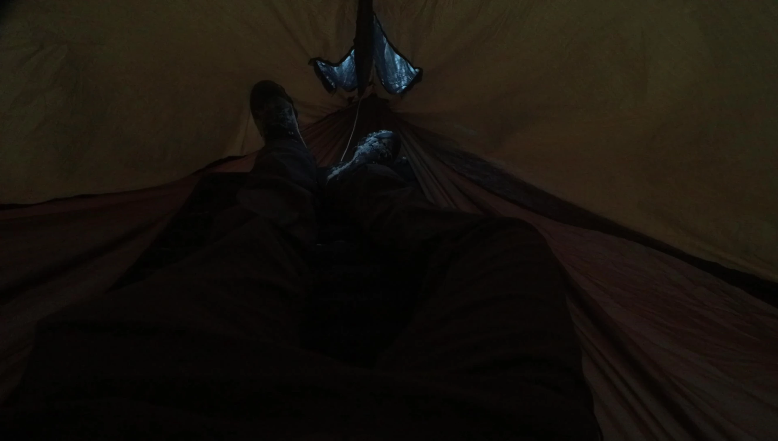 A person comfortably lying inside the hammock, demonstrating its spaciousness.