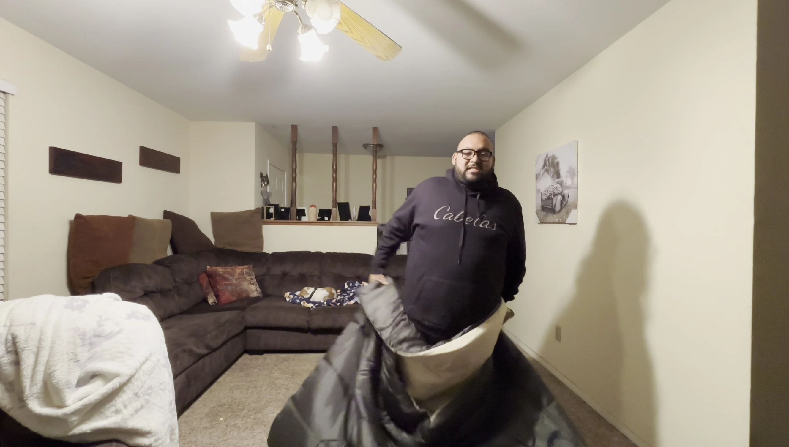 The sleeping bag laid out on the floor, showcasing its size and weight