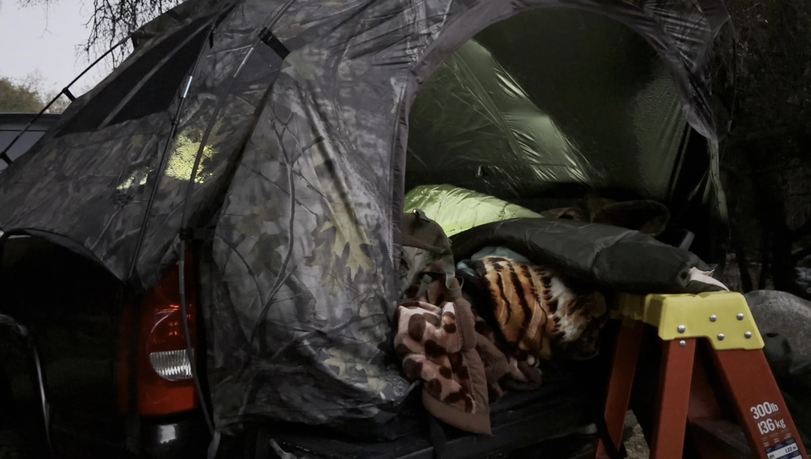 Close-up shot of the sleeping bag being placed in the tent