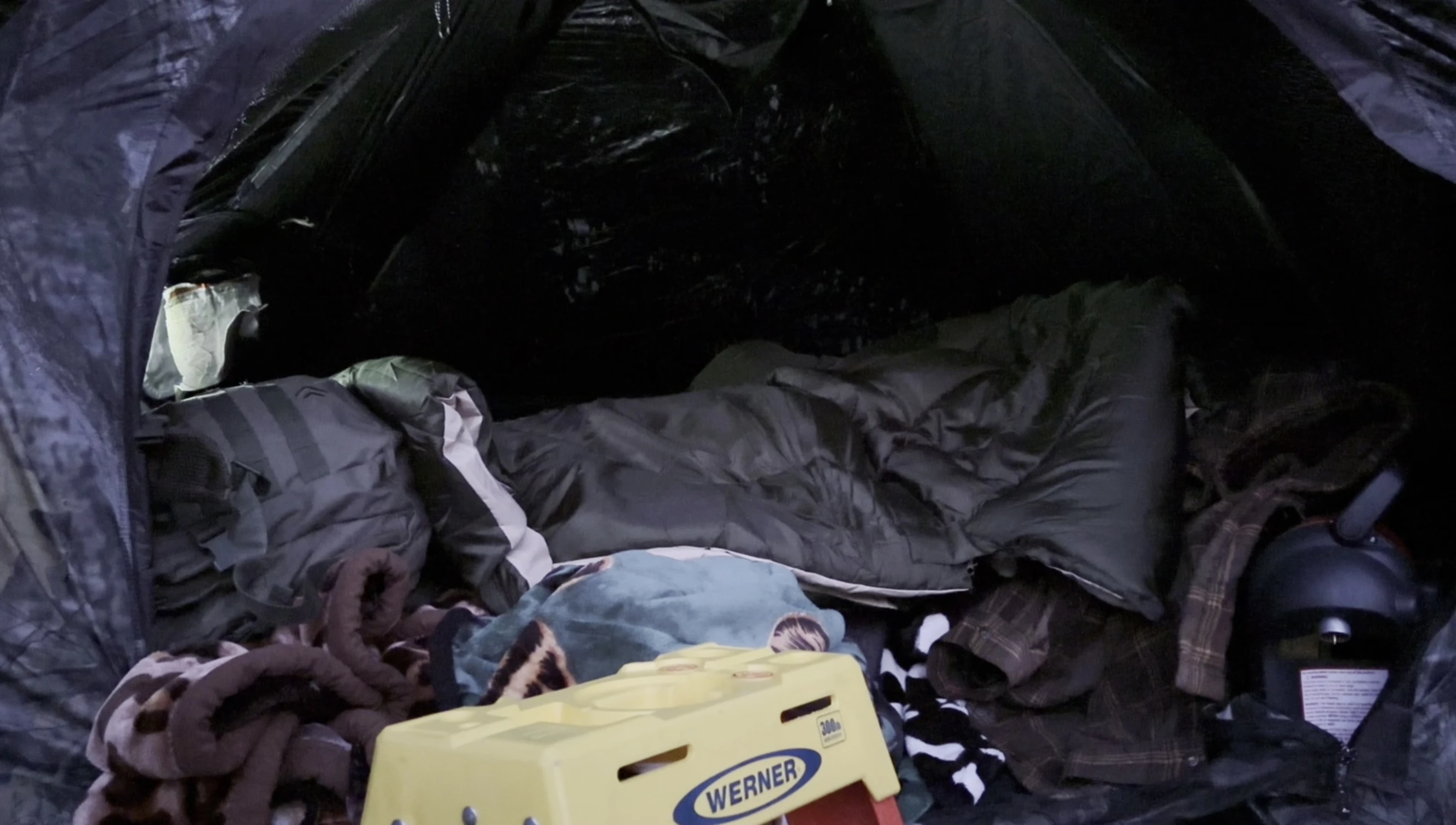 Overview of the reviewer's entire camping setup, showing tent, mattress, and sleeping bag