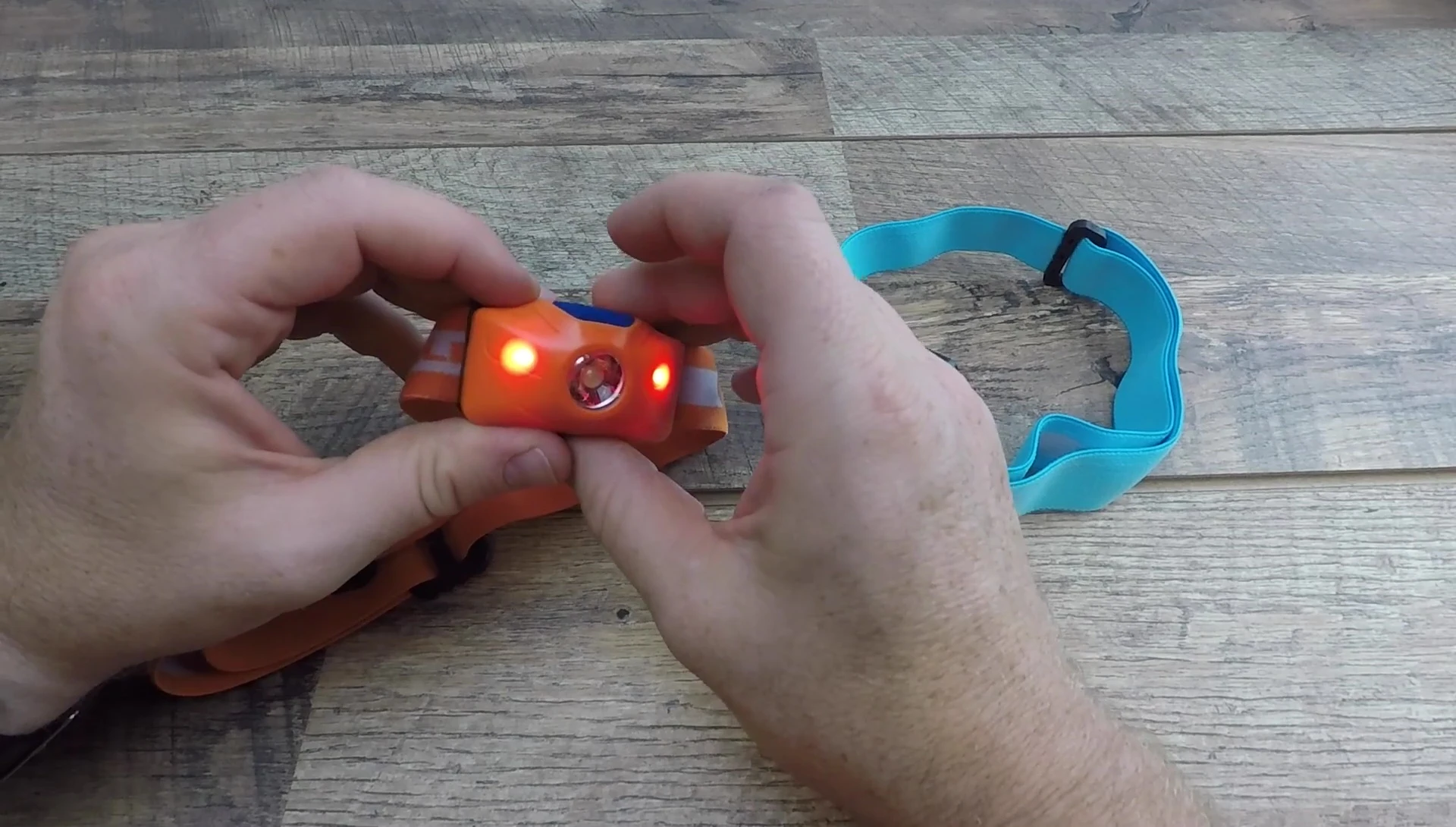 Hand demonstrating the button operation and modes