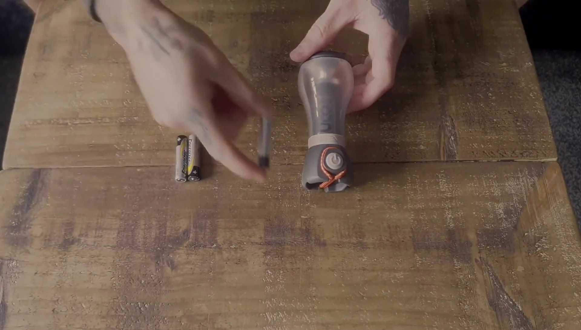Comparison of the ALKI lantern size to a AAA battery.
