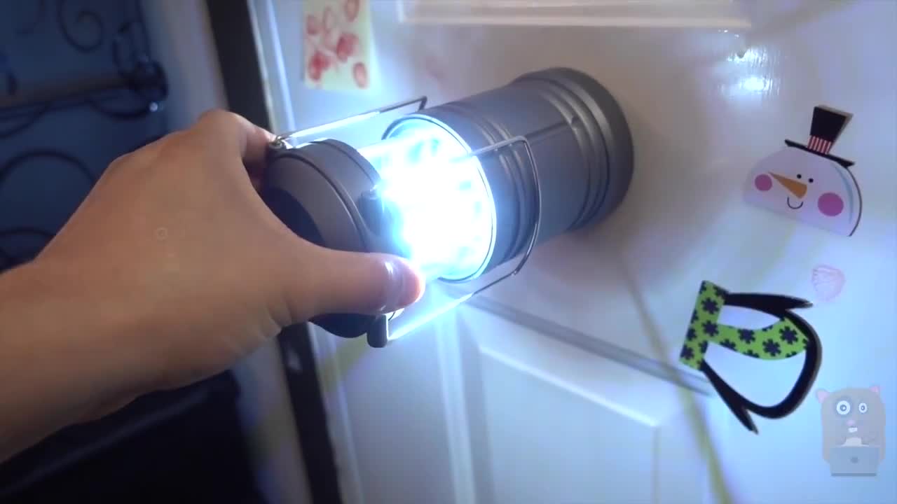 Demonstrating the folding mechanism of the lantern.