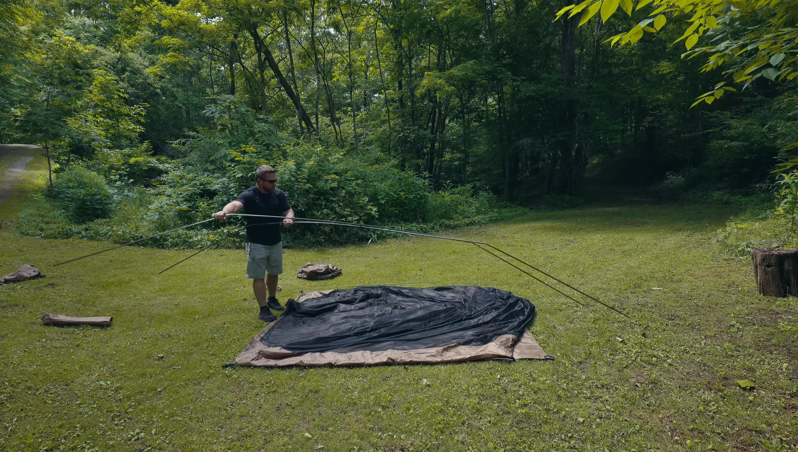Person demonstrating the ease of setting up the tent.