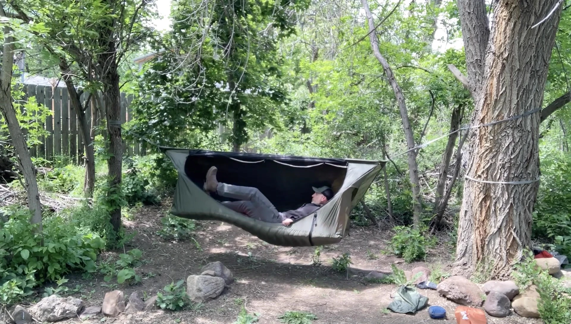 The reviewer demonstrating the lay-flat nature of the hammock tent