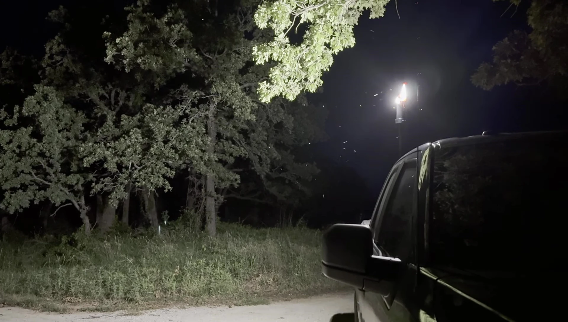 The lantern positioned on a truck bed, illuminating a distance