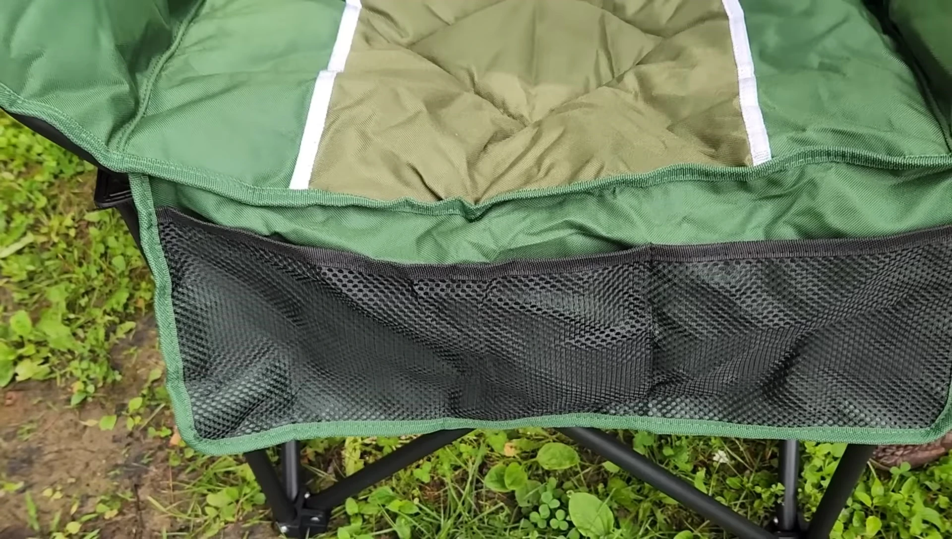 The wine glass holder on the side of the chair.