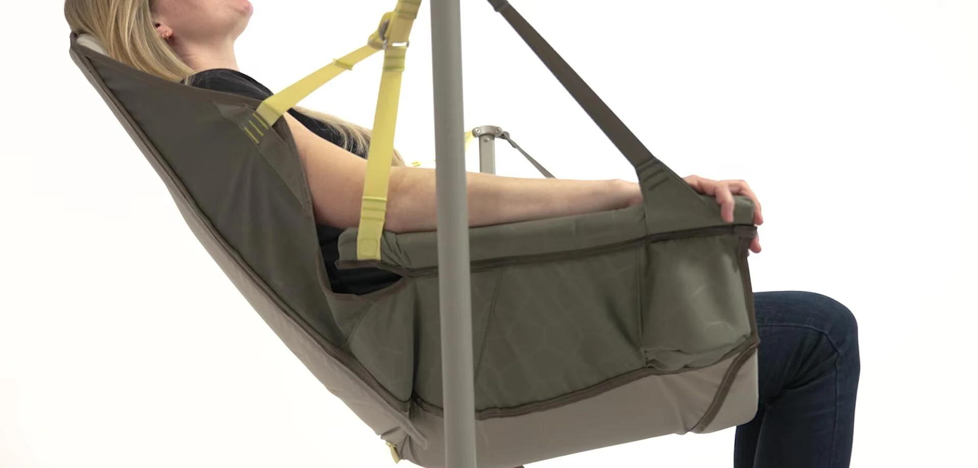 Person relaxing in the chair, showcasing its stability and swinging motion.