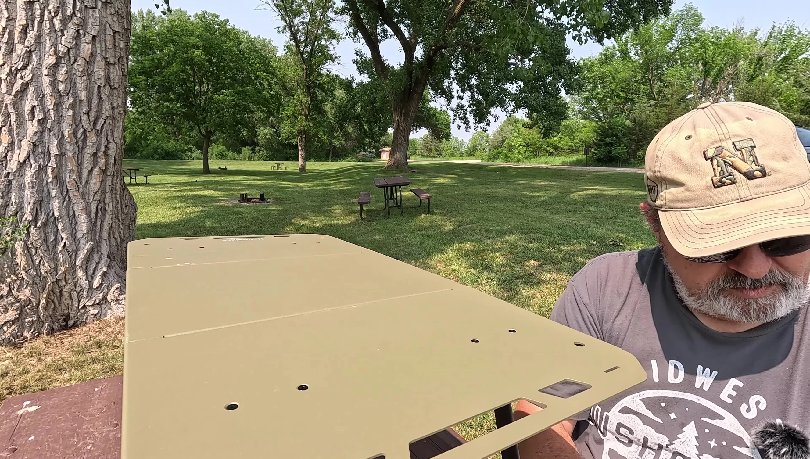 The mesh basket attached to the underside of the table.