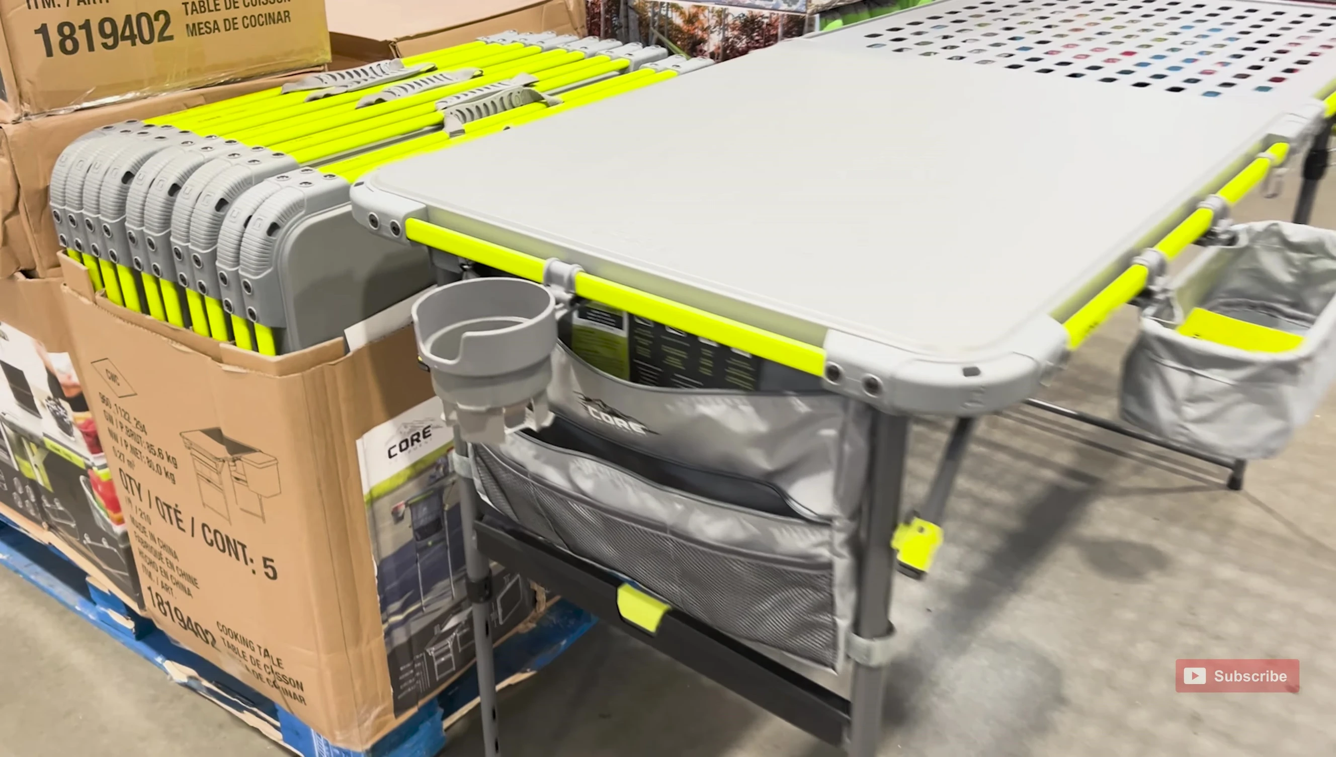 Detailed shot of the table's accessories, including cup holders, hooks, and storage pockets.