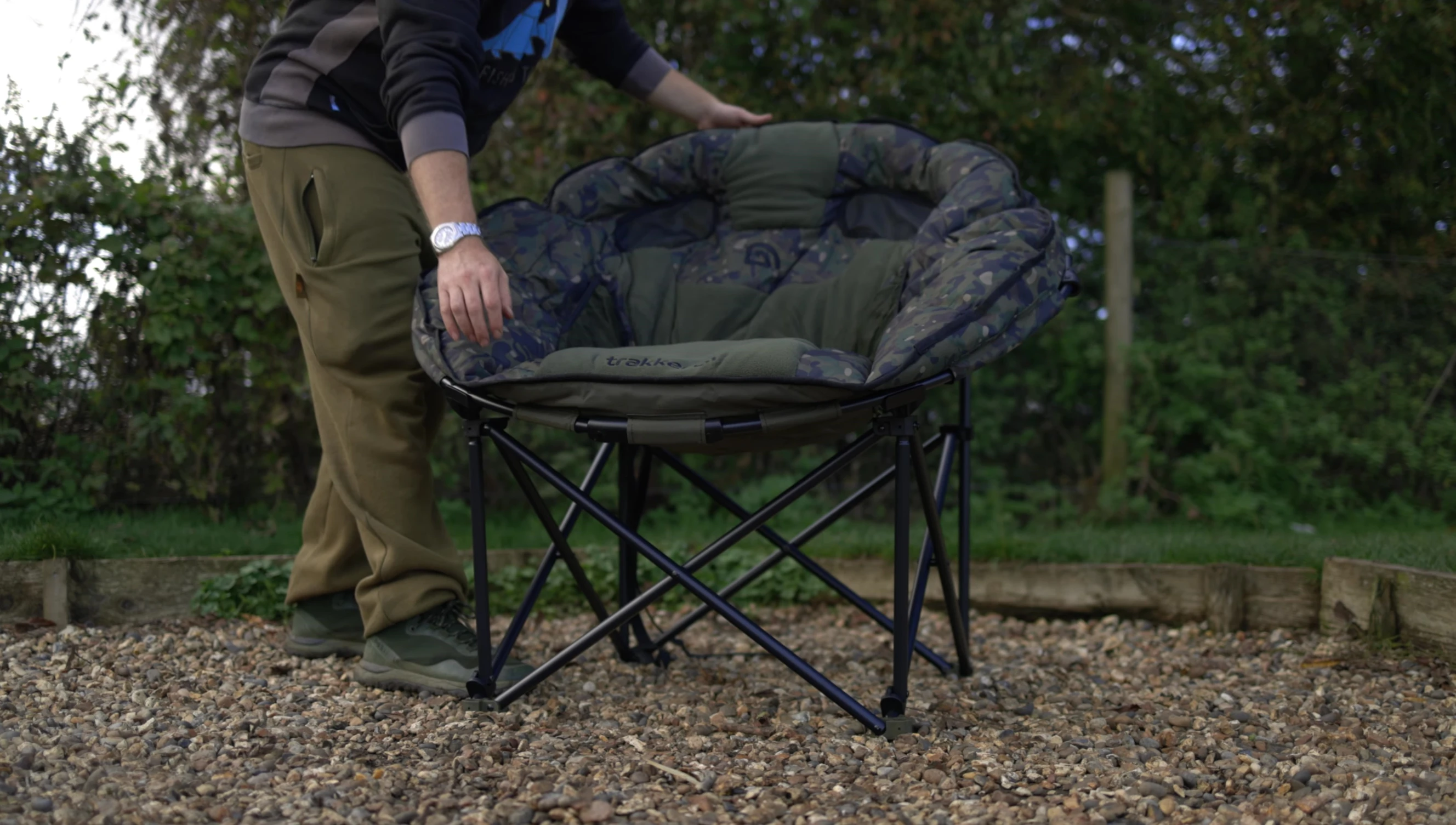 The chair being folded up and packed into its carry bag.