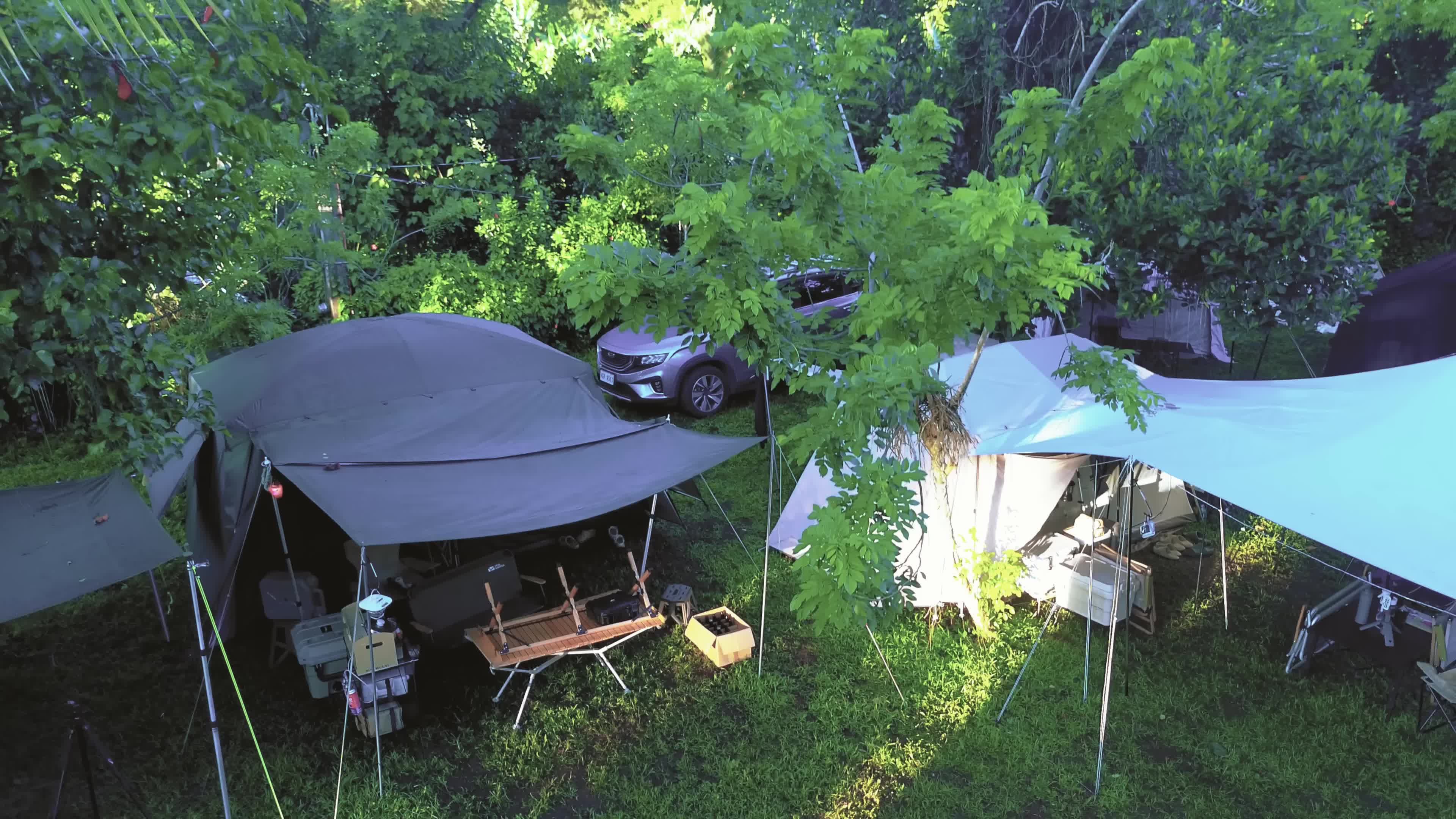 A shot of campers struggling with their tent in varied weather conditions