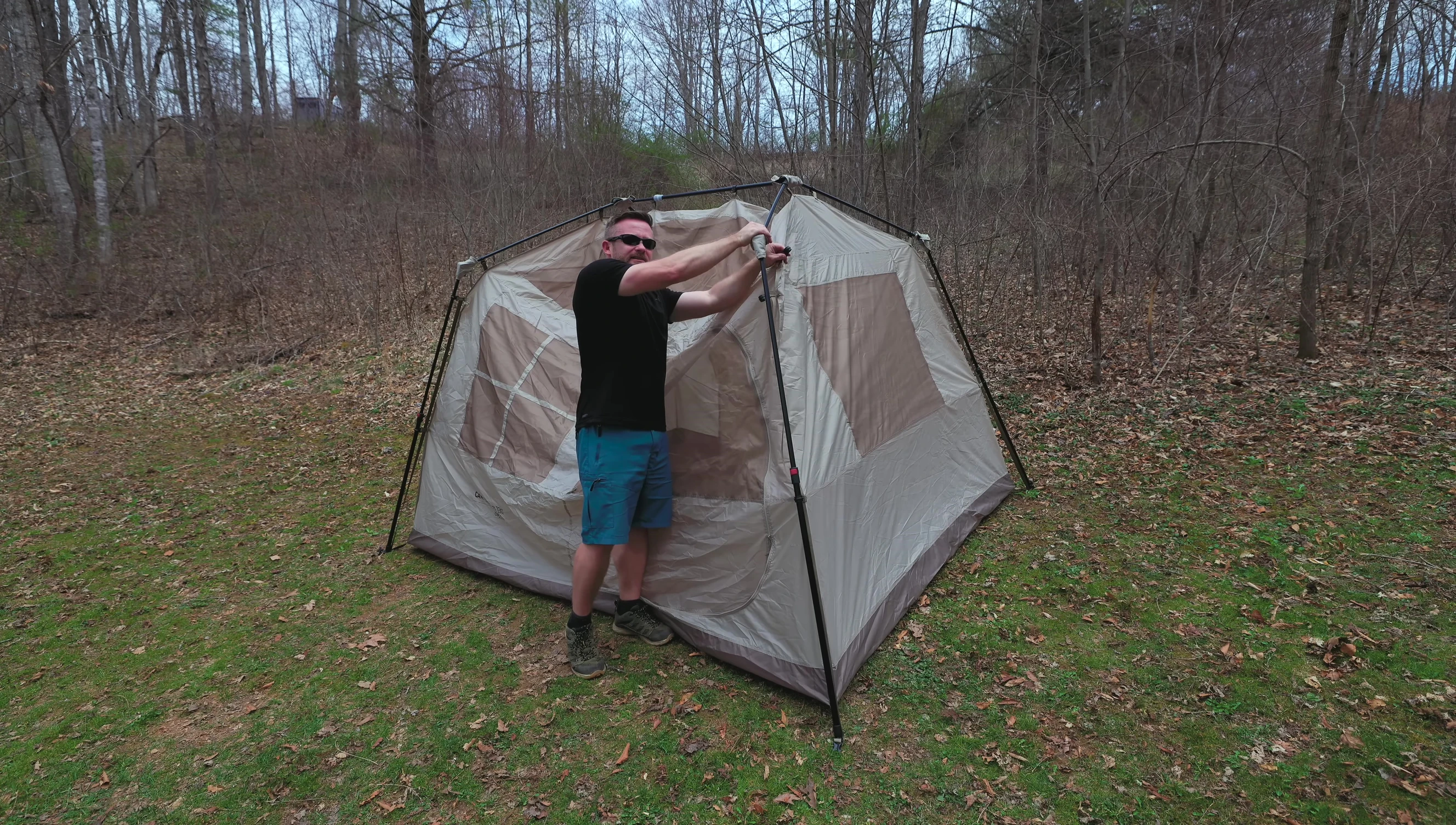 Person disconnecting clips on the tent