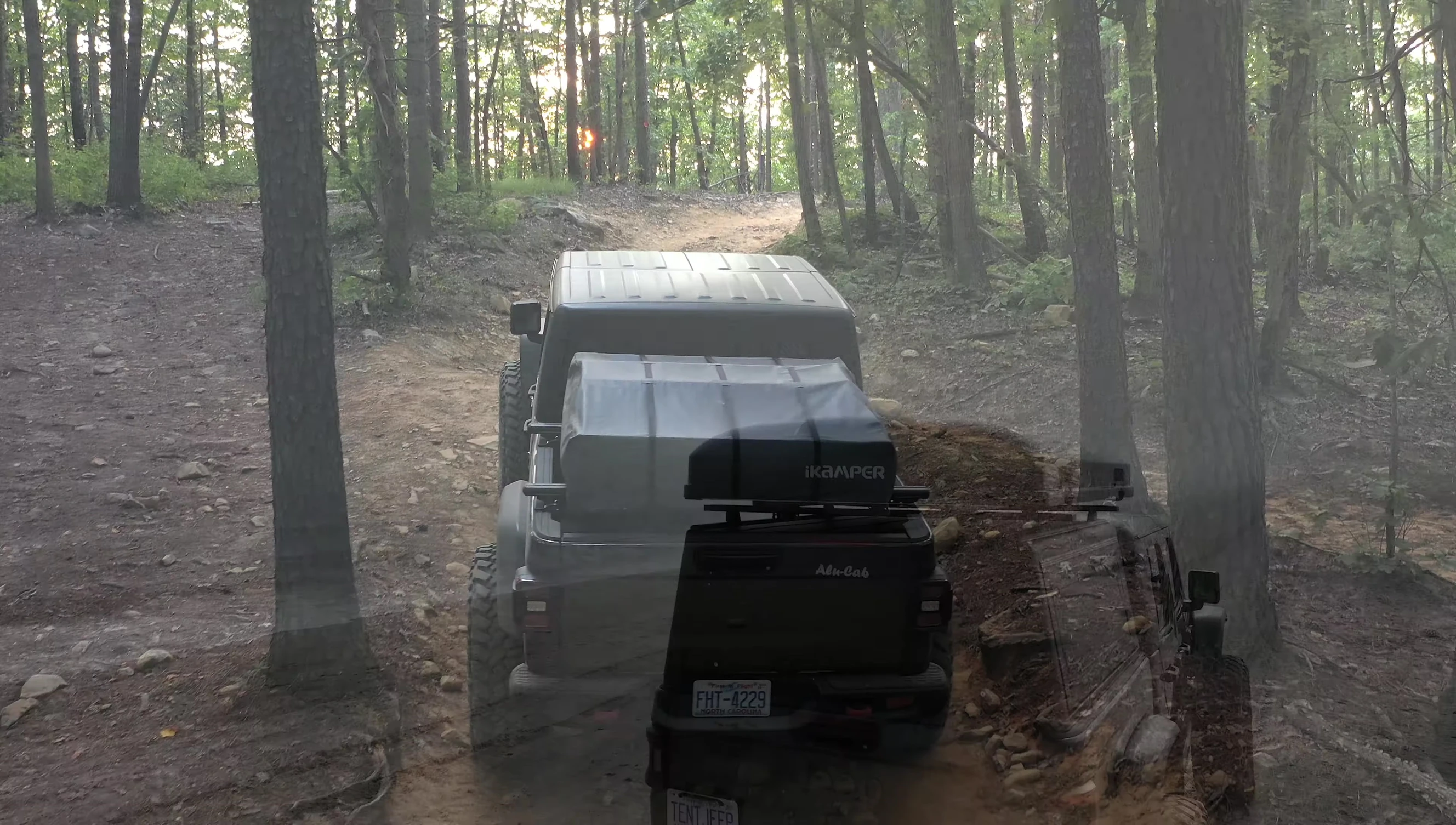 The speaker comparing weights of the two rooftop tents