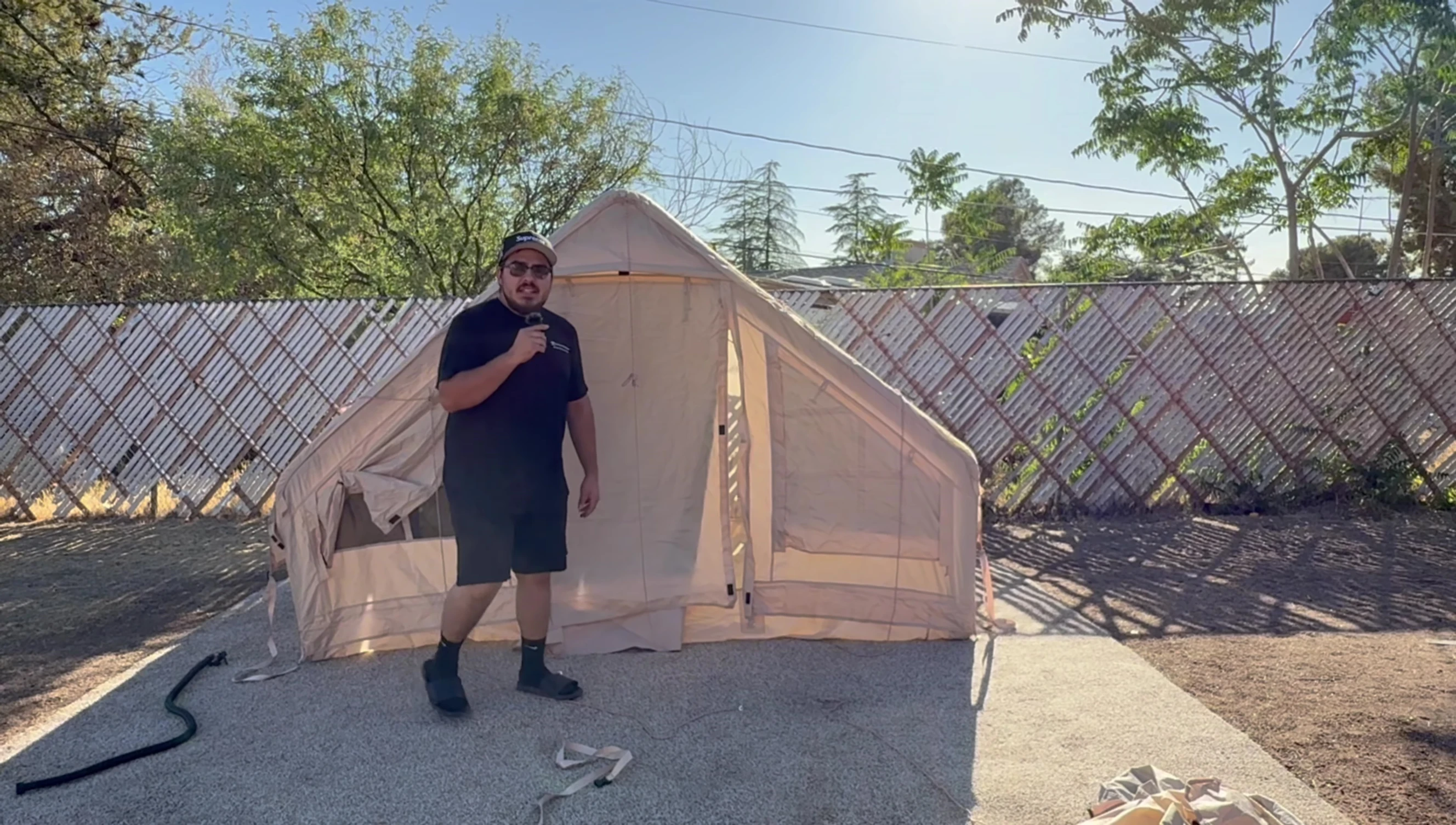 The user demonstrating the ease of setting up the tent.