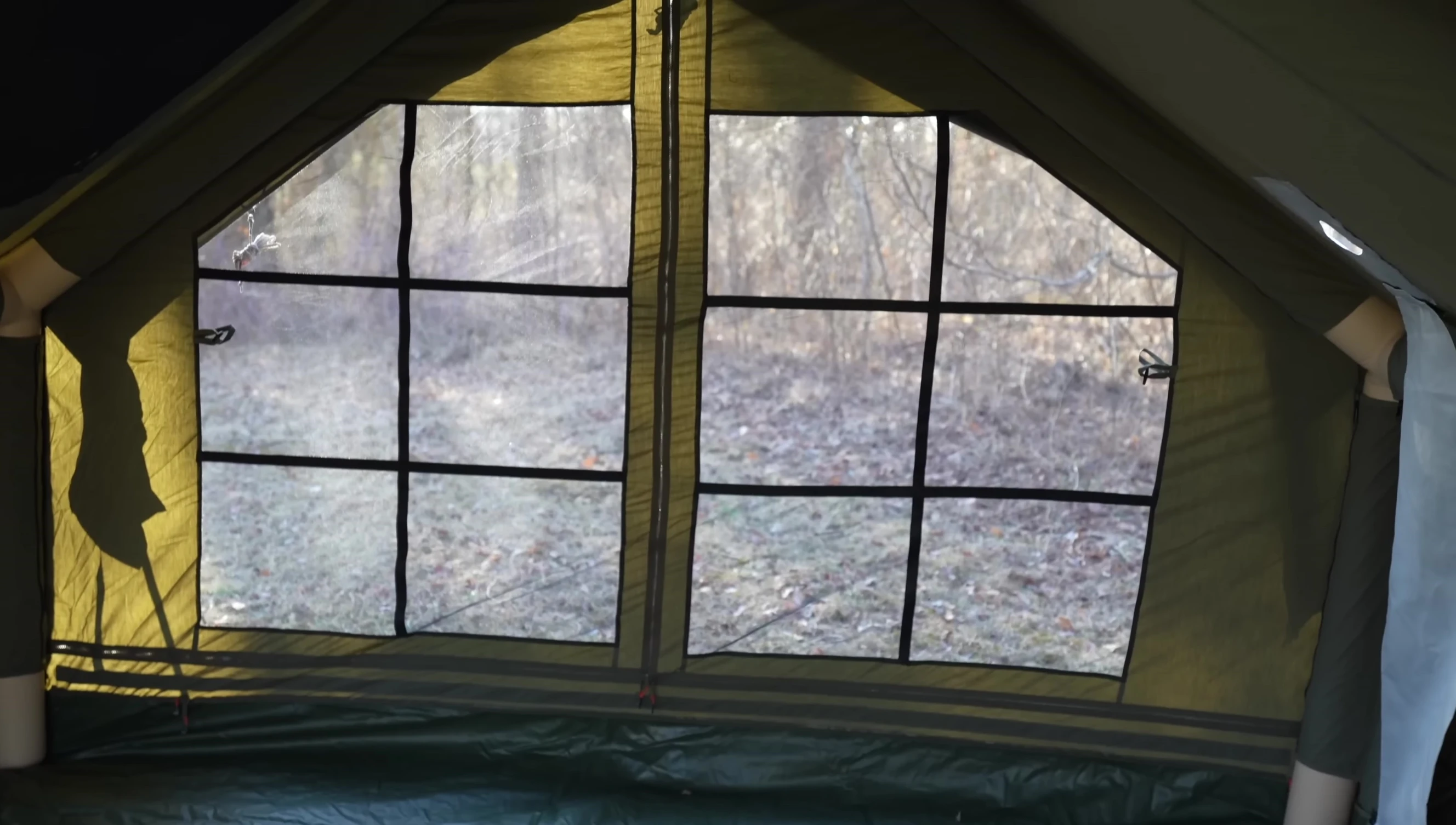 Interior view of the tent showing the main beams and skylights.