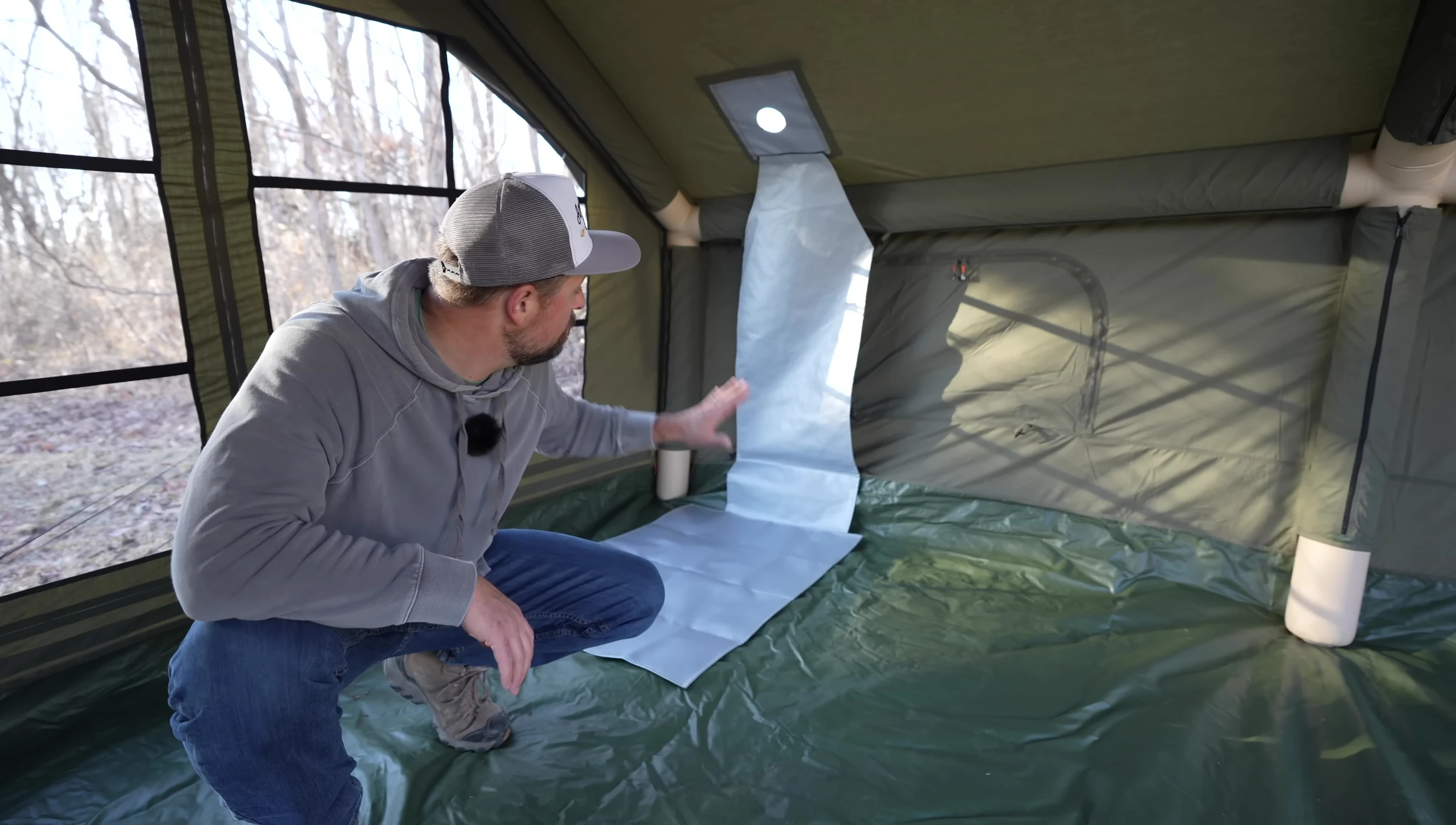 Setting up the stove inside the tent with heat shielding.
