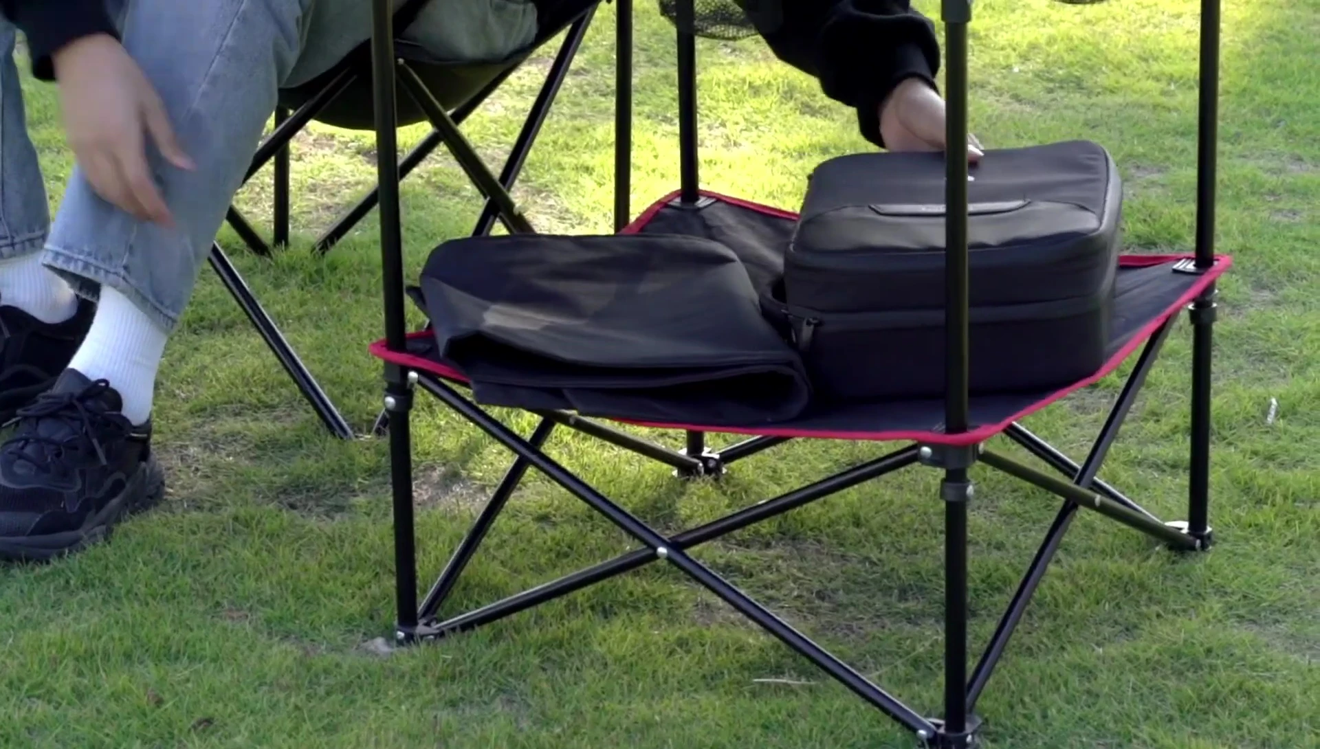 The round table folded and in its carrying bag