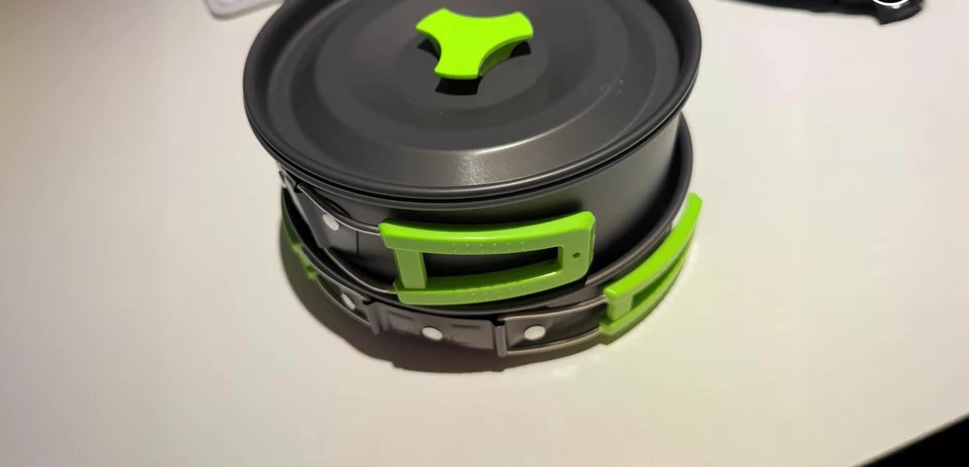 Close-up of the foldable handle and nesting design.