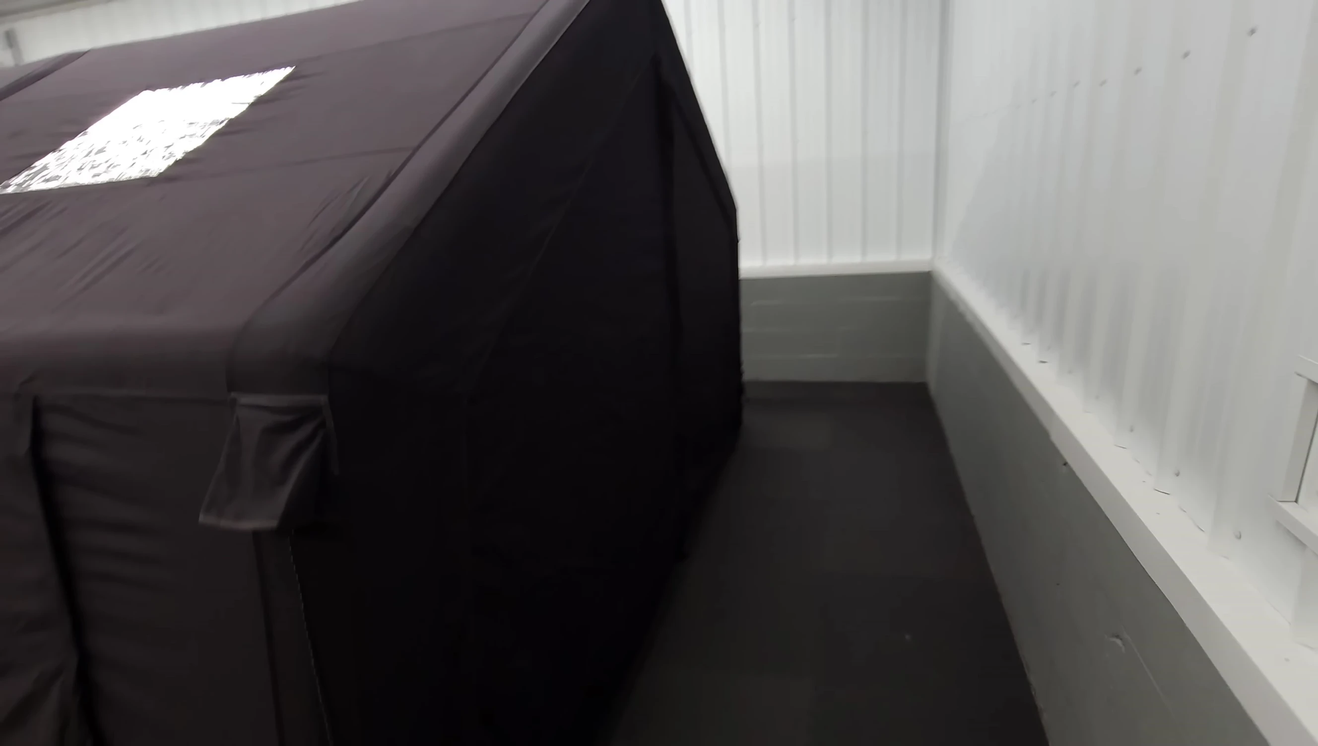 The removable back panel of the tent.