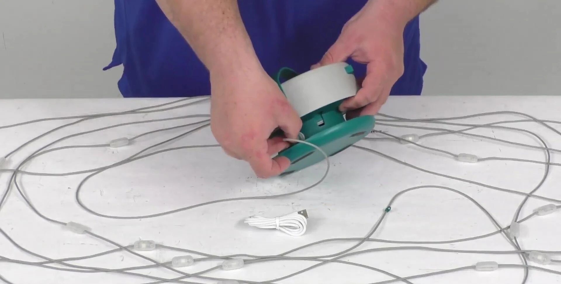 Plugging the lights into the storage case.